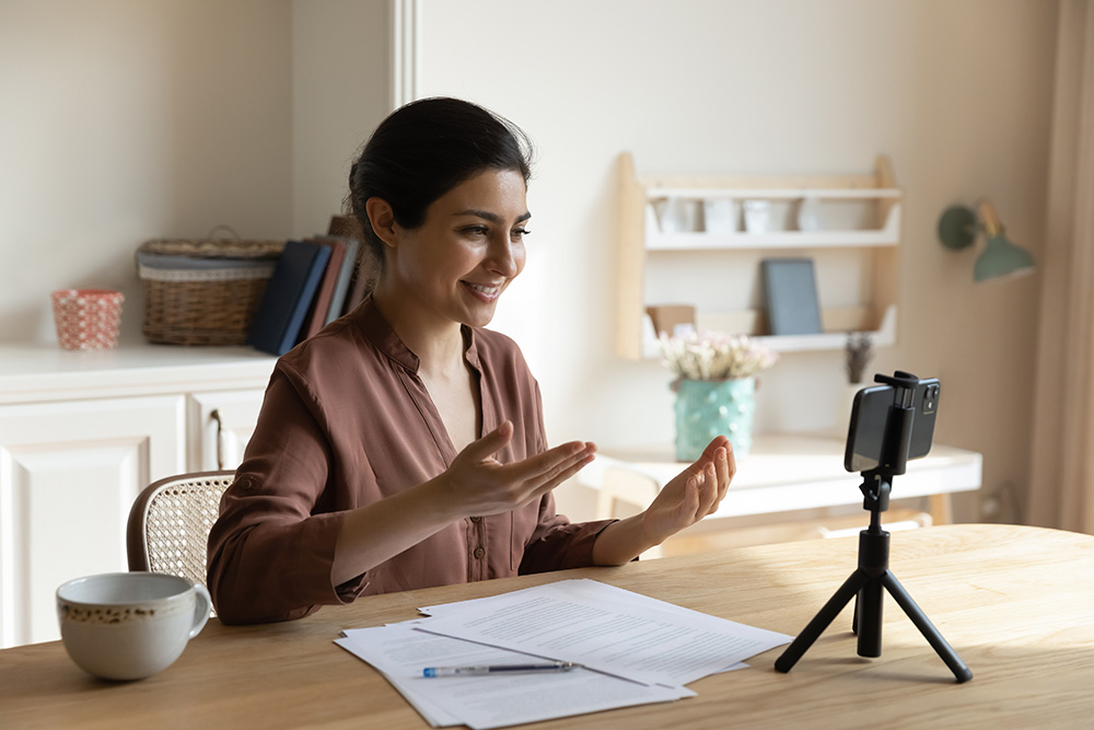 Mixed race female meditation instructor shoot lecture course on phone webcam